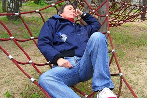 man-sleeping-at-playground-200-300